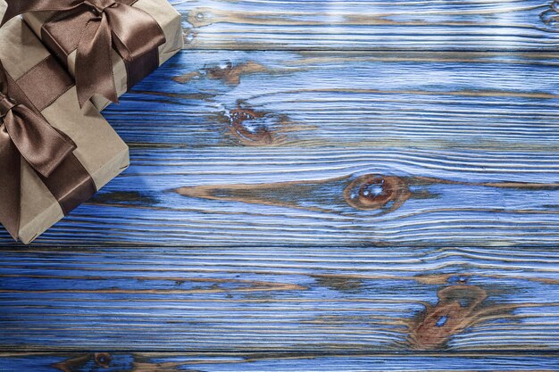 Brown wrapped birthday presents on vintage wooden board