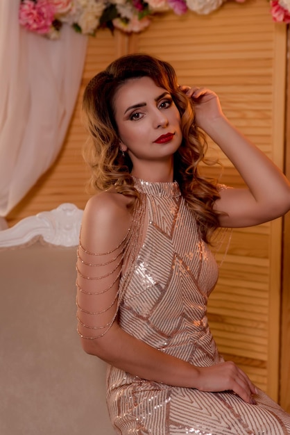 Browneyed brunette near the window  posing in a chair