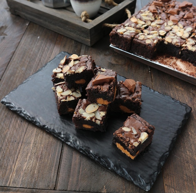 Photo brownie pieces arranged on a stone tray on a wooden table