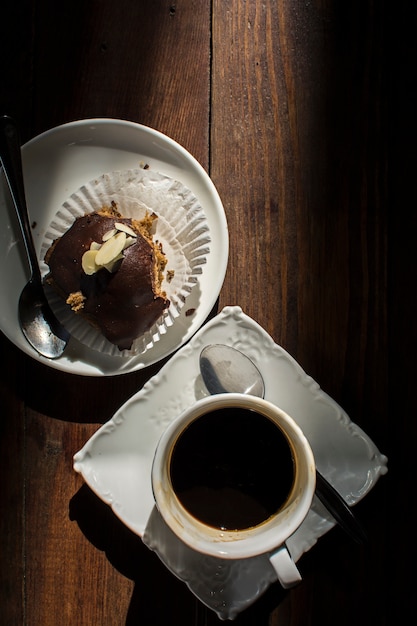 Brownie with cup of espresso coffee on wooden table