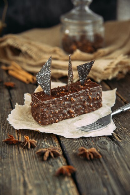 Brownie on wooden table with fork. Country style