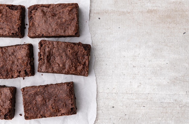 Brownies pieces over white wooden table with copy space