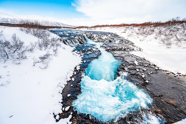 Bruarfoss waterfall the \'iceland\'s bluest waterfall\' blue water\
flows over stones winter iceland visit iceland