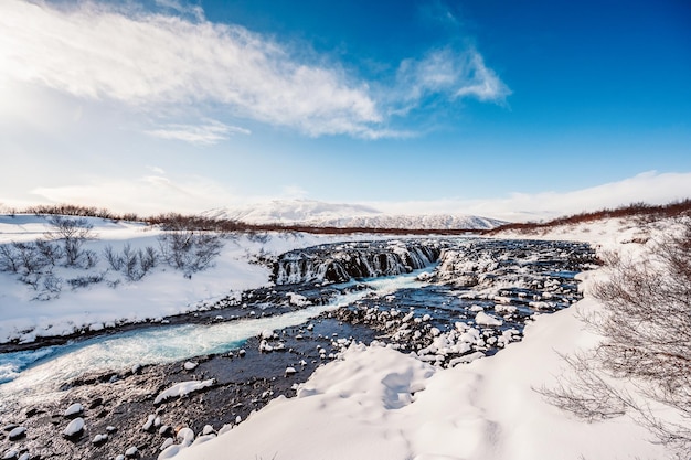 Bruarfoss waterfall the \'iceland\'s bluest waterfall\' blue water\
flows over stones winter iceland visit iceland