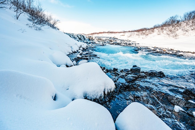 Bruarfoss waterfall the \'iceland\'s bluest waterfall\' blue water\
flows over stones winter iceland visit iceland