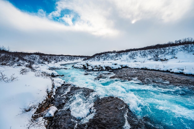 Bruarfoss waterfall the \'iceland\'s bluest waterfall\' blue water\
flows over stones winter iceland visit iceland