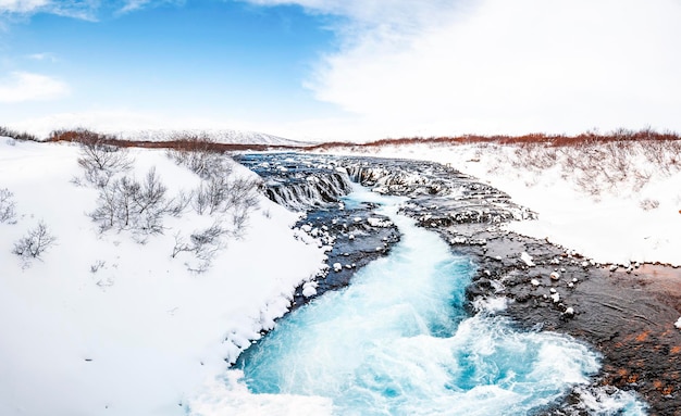 Bruarfoss waterfall the \'iceland\'s bluest waterfall\' blue water\
flows over stones winter iceland visit iceland