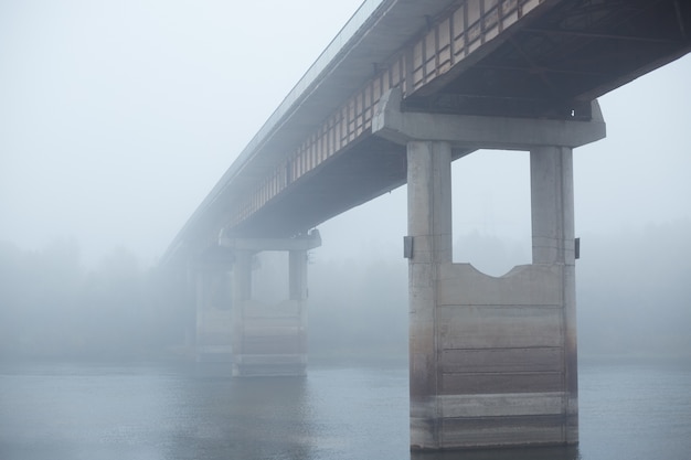 Brug in mist, betonnen brug door de rivier