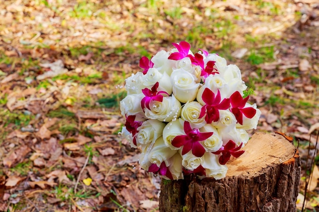 Bruiloft bruidsboeket met witte orchideeën, rozen, madeliefjes en rode bessen