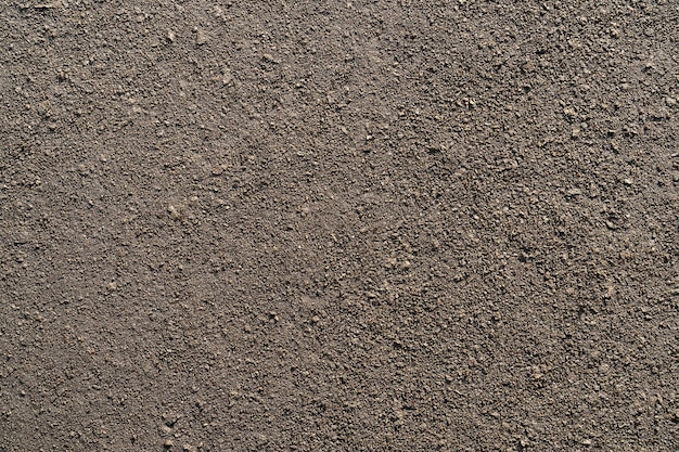 Bruine bodemtextuur met kleine klontjes als achtergrond