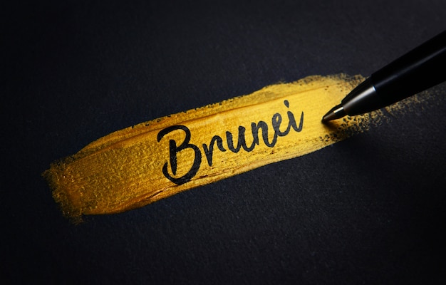 Brunei Handwriting Text on Golden Paint Brush Stroke