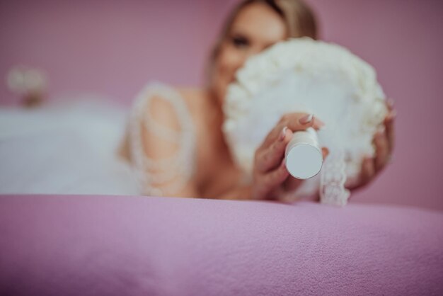 Brunet bride posing in pink studio