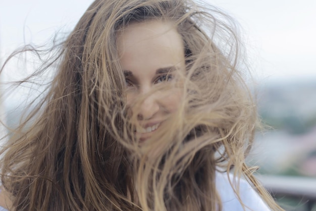 Brunette beautiful disheveled hair portrait on the beach hairstyle