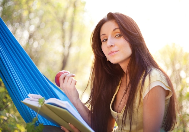 Brunette beautiful woman relaxing in a hammock