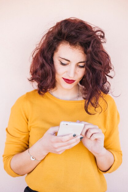 Brunette blogger using mobile phone