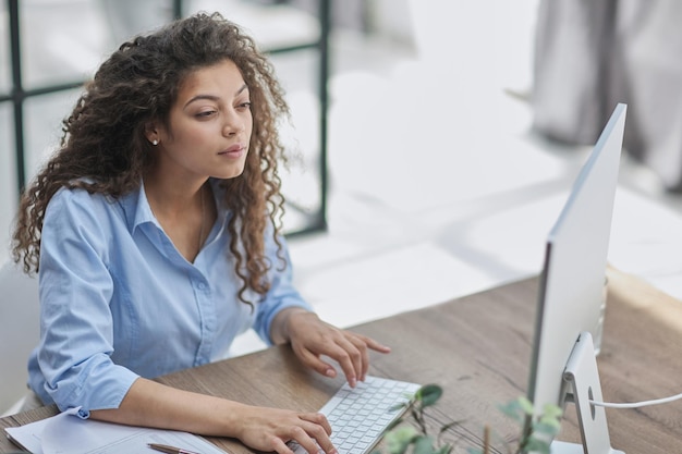 Photo brunette business woman using headset to communicate and advise people in customer service office