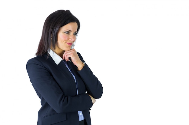 Brunette businesswoman thinking with hand on chin