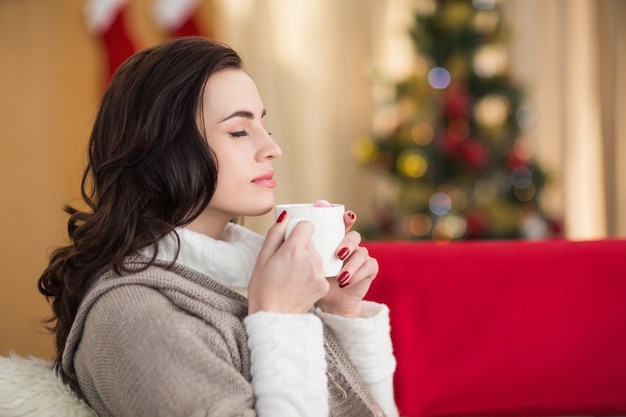 Brunette enjoying a hot chocolate at christmas