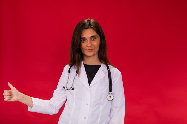 brunette female doctor shows thumb up