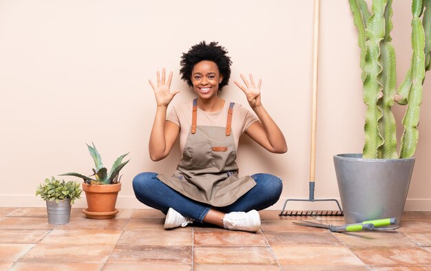 brunette gardener woman sitting on the floor