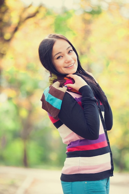 Brunette girl at autumn alley in the park