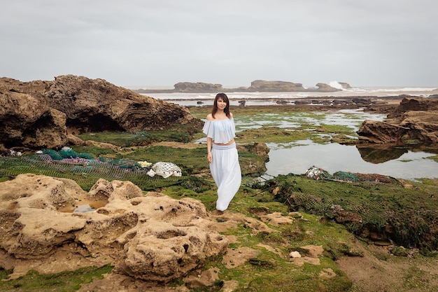 Brunette girl on the coast of the Atlantic Ocean. Essaouira. Morocco