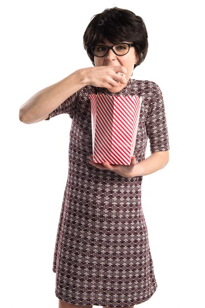 Brunette girl eating popcorns