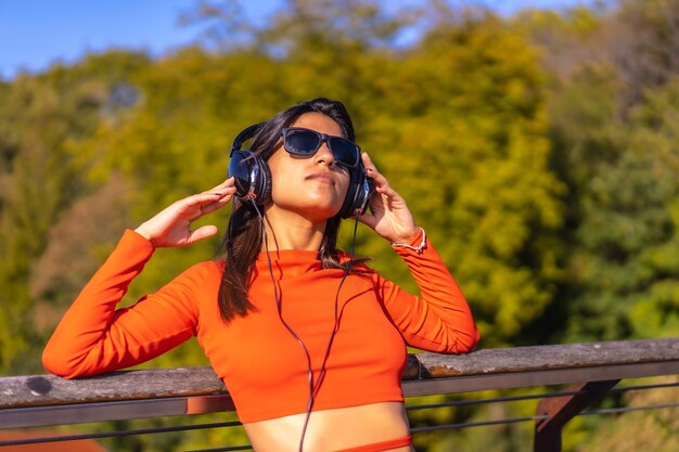 Brunette girl enjoying a sunny autumn afternoon in the park