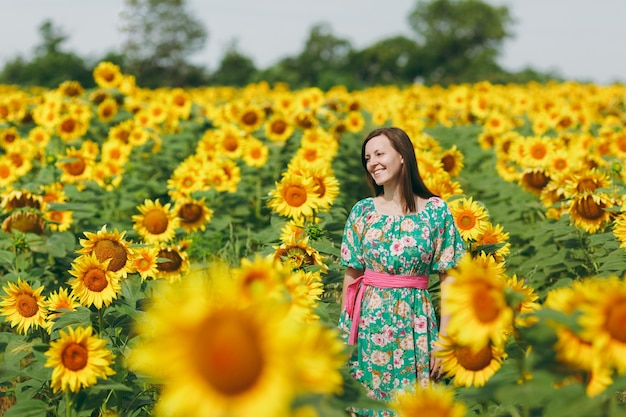 The brunette girl in a field of sunflowers