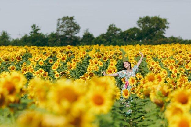 The brunette girl in a field of sunflowers