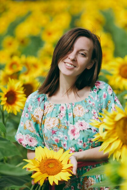 The brunette girl in a field of sunflowers