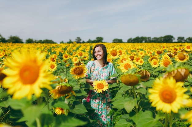 The brunette girl in a field of sunflowers