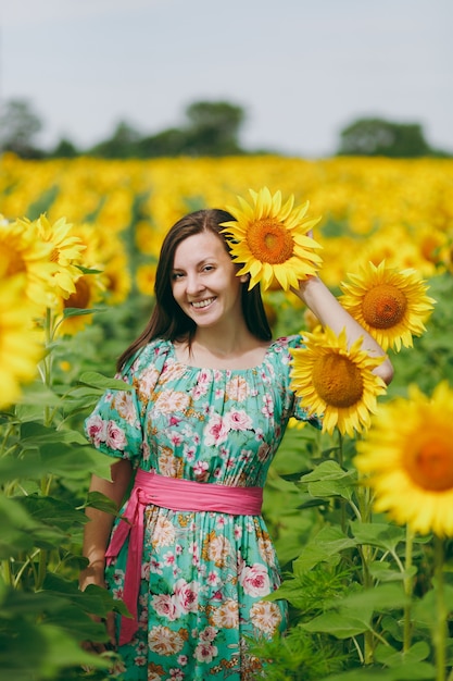 The brunette girl in a field of sunflowers