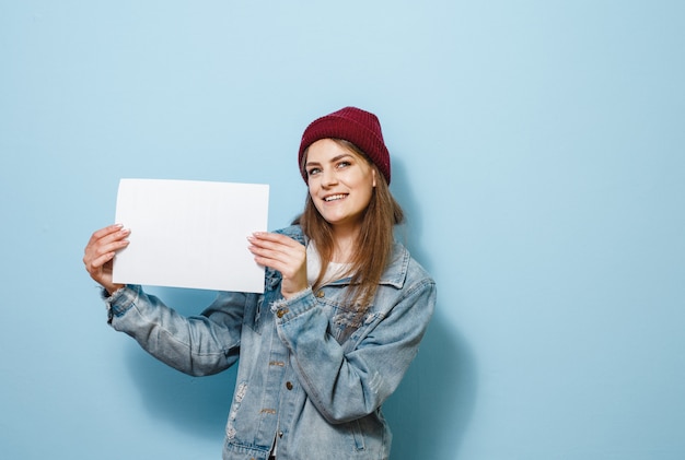 A brunette girl holding a white panel