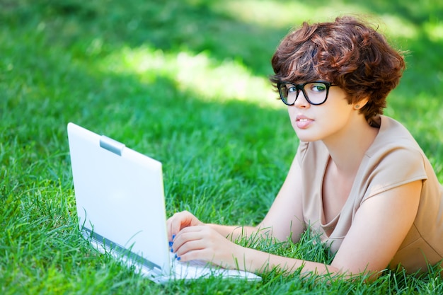 Brunette girl with notebook at outdoor.