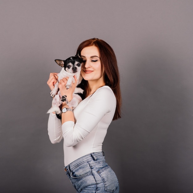 Brunette holding chihuahua