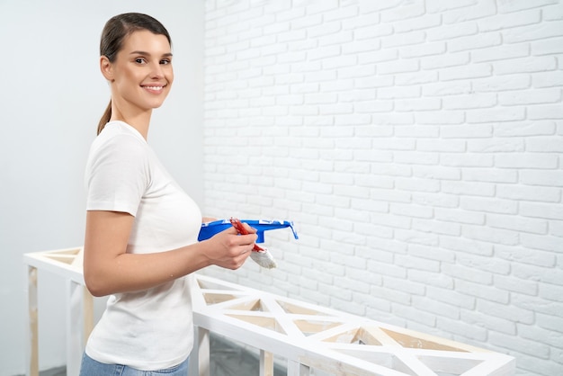 Brunette holding paint and brushes for drawing