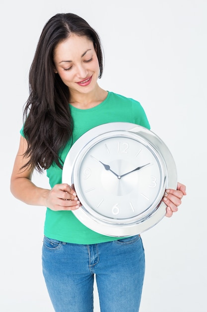 Brunette holding wall clock