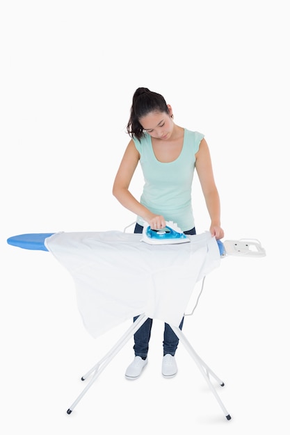 Brunette ironing shirts