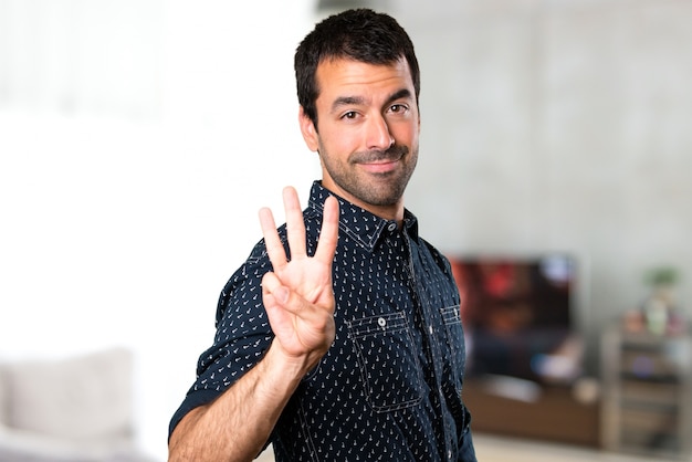 Brunette man counting three inside house