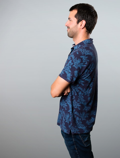 Brunette man looking lateral on grey background