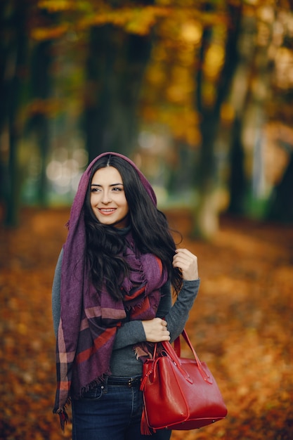 brunette meisje ontspannen in het park in het najaar