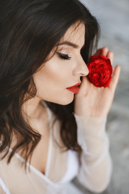  brunette model with red lips and bright makeup