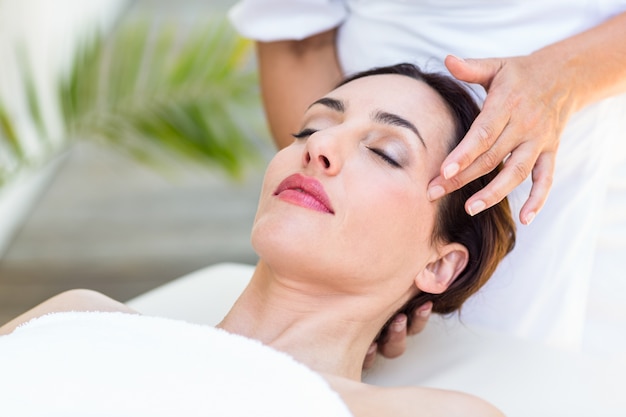 Brunette receiving head massage