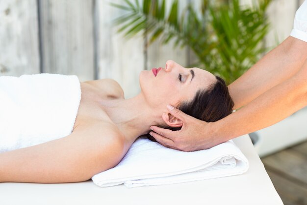 Brunette receiving head massage