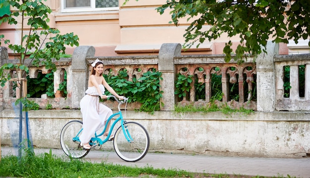 brunette riding blue bike