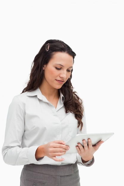 Brunette standing while using a touchpad