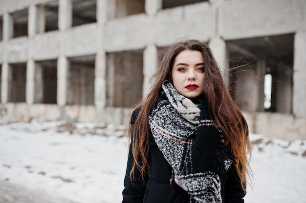 Brunette stylish casual girl in scarf against abandoned factory place.