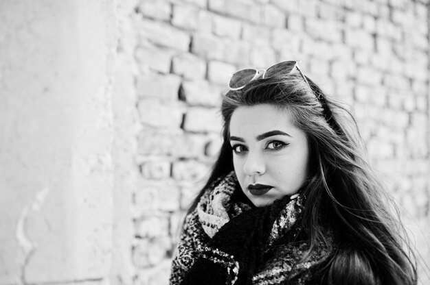 Brunette stylish casual girl in scarf against abandoned factory place.