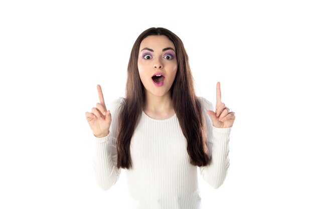 Brunette teenager girl with purple makeup isolated on a white background